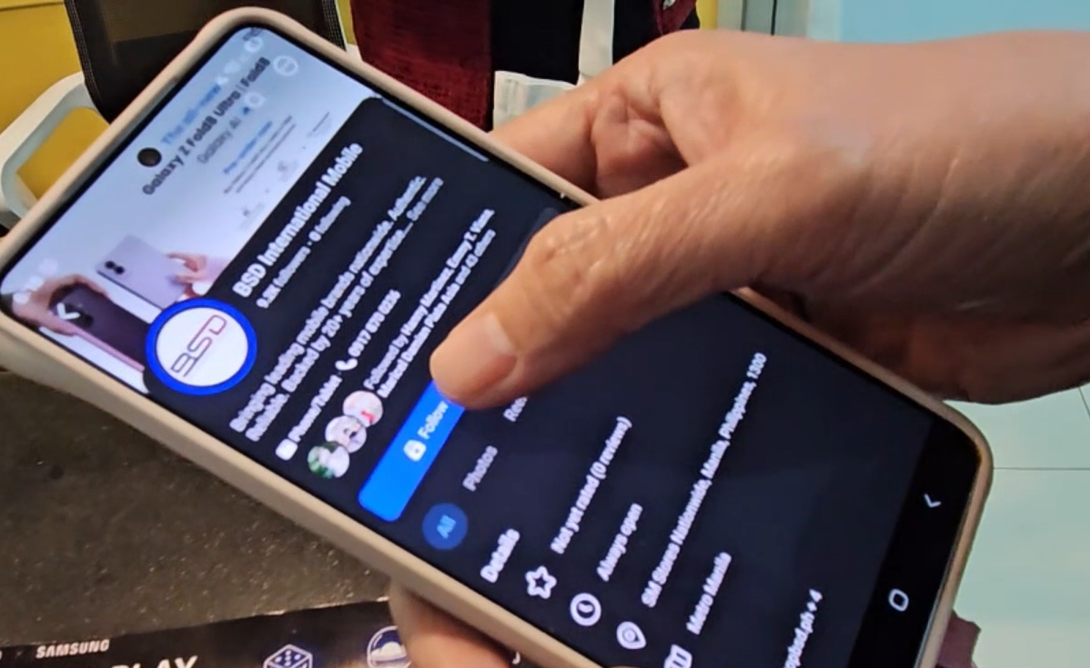 Customer following the BSD International Facebook page on their phone in-store